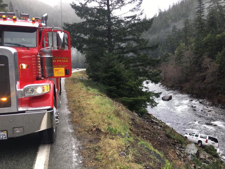 SUV goes from road into river