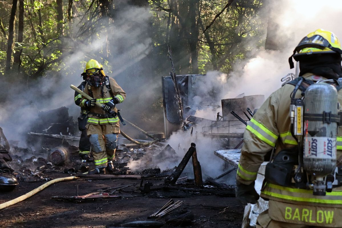 Firefighters work the scene of a blaze near Elk Valley Road and Michigan Avenue